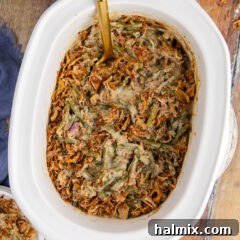 Overhead photo of Green Bean Casserole in a Crockpot with a spoon in it