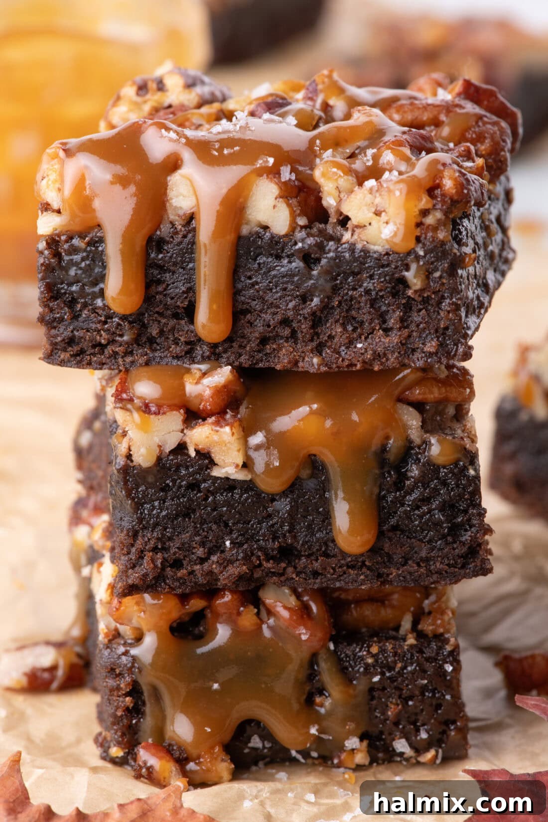 Stack of three Pecan Pie Brownies with caramel drizzled on top