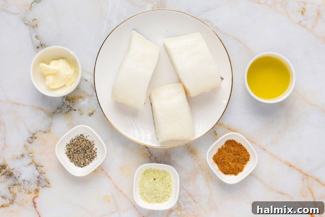 Golden Pan-Seared Chilean Sea Bass 4 All the fresh ingredients laid out for Pan Seared Chilean Sea Bass, including fish, butter, and seasonings.