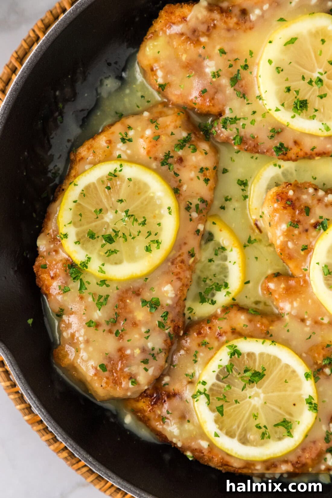 Close up image of Lemon Chicken in a skillet with sauce