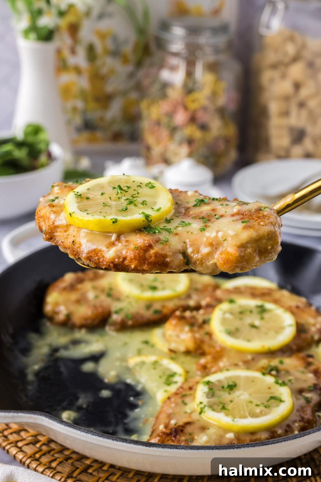 Spatula holding up a piece of Lemon Chicken