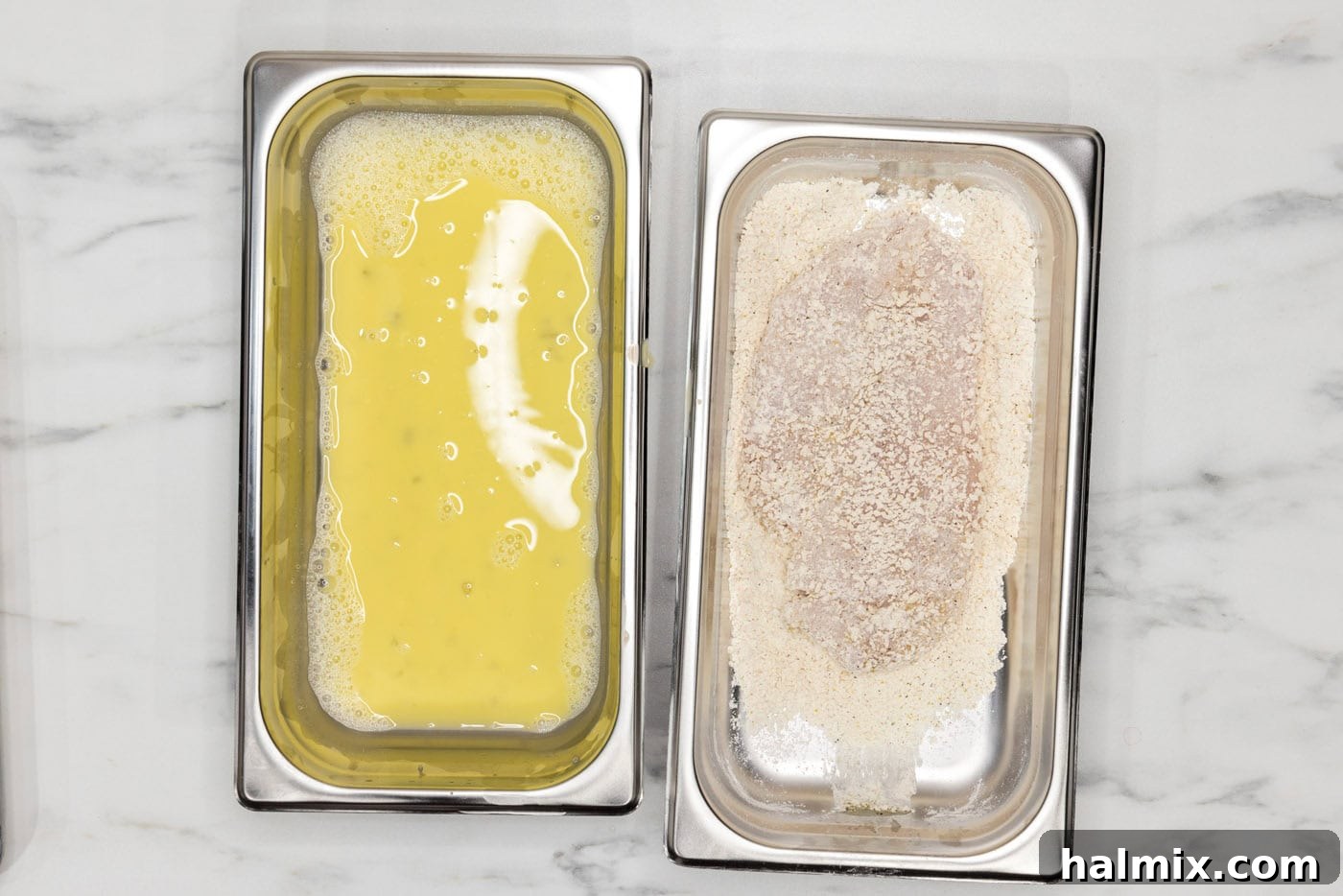 chicken breast coating in breadcrumb mixture in a breading tray