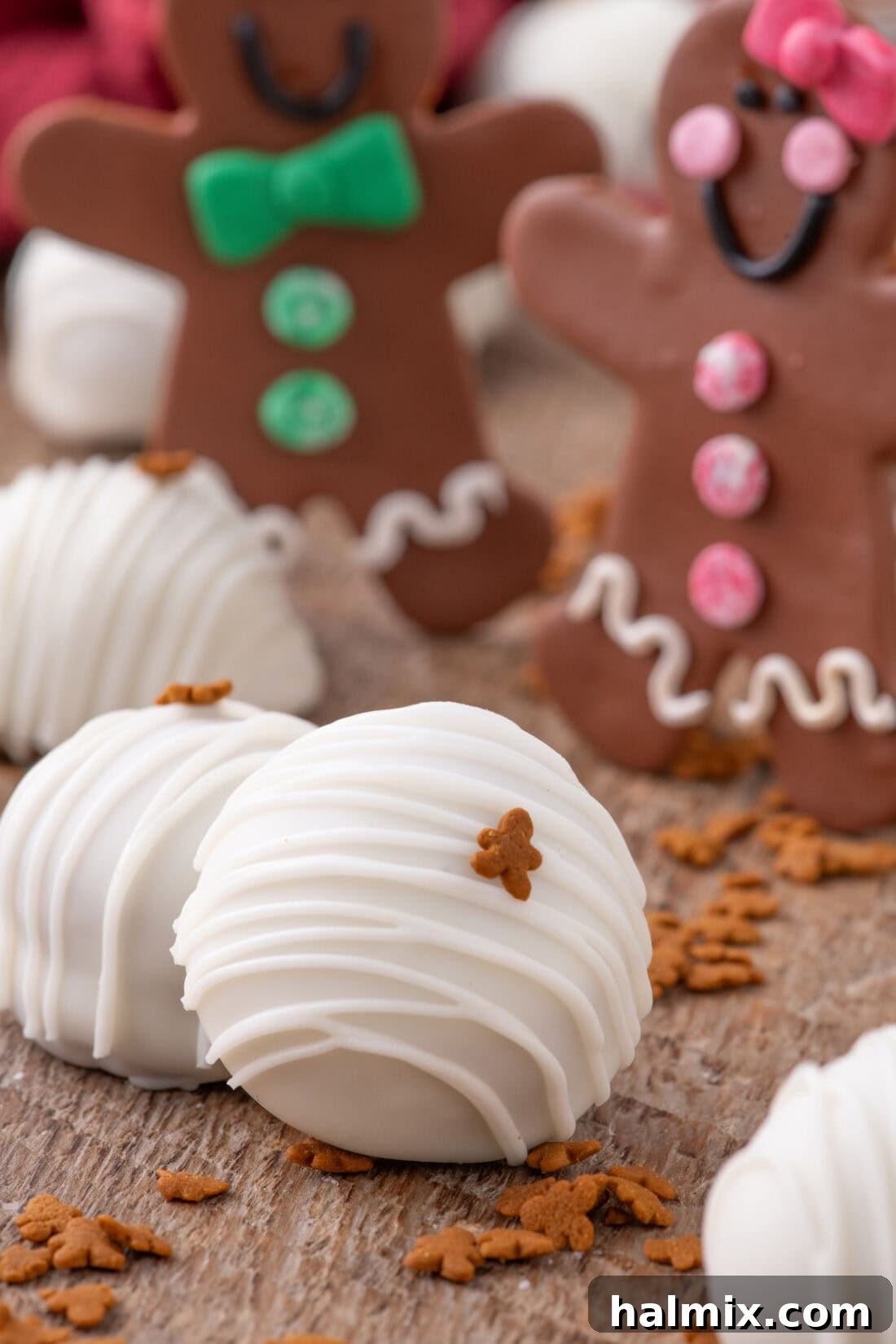 Close up photo of a Gingerbread Oreo Truffle with gingerbread cookies in the background