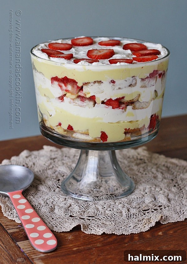 A beautiful English trifle sitting on a wooden table, ready to be served
