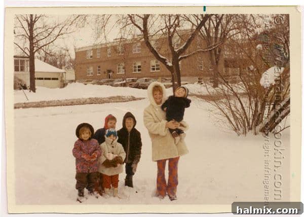 Old family photo from 1969 featuring the author as a child in a white coat, her older brother, her mother holding baby Michael, and two new friends