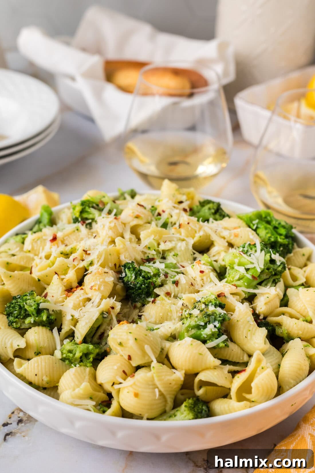 Close up photo of a bowl of Broccoli Pasta, showing the texture of the pasta shells and broccoli florets coated in sauce.