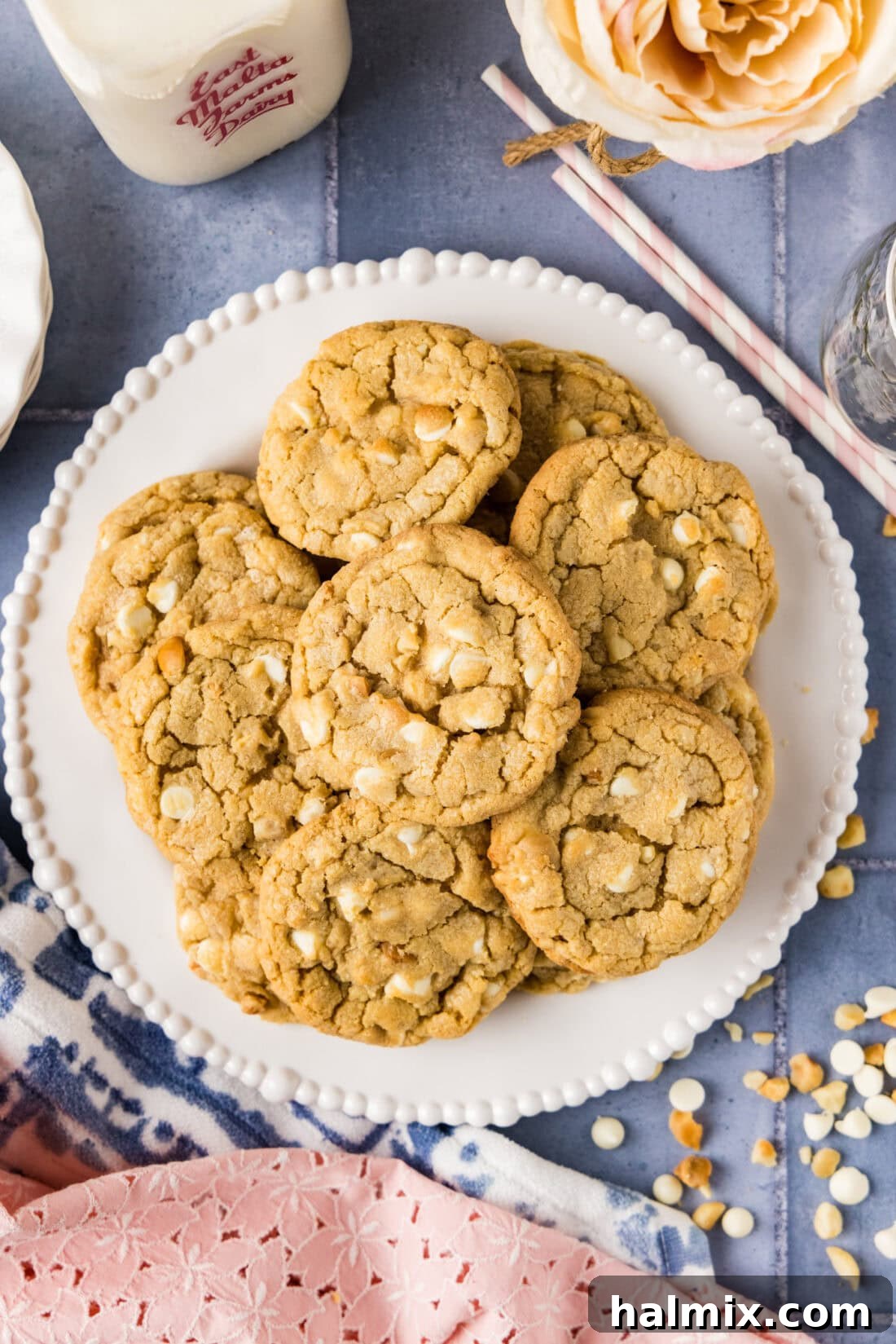 A beautifully arranged plate of golden-brown White Chocolate Macadamia Nut Cookies, showcasing their appealing texture and abundant fillings.
