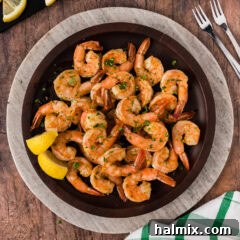 Plate of Steamed Shrimp with lemon wedges on the side, ready to be enjoyed.