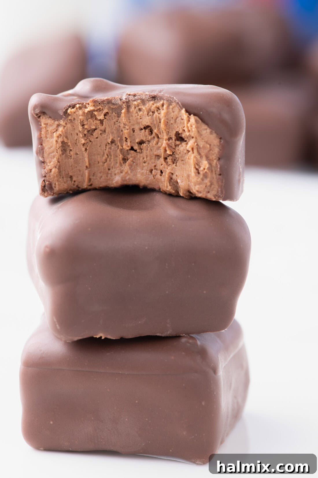 Creamy Cloud Bites 2 Stack of three homemade Cool Whip Candies, showcasing their dark chocolate coating and soft interior.