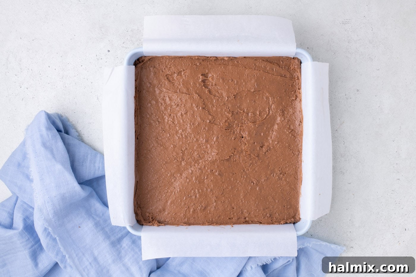 Creamy Cloud Bites 9 Chilled and hardened whipped chocolate mixture in a baking pan, ready for cutting.
