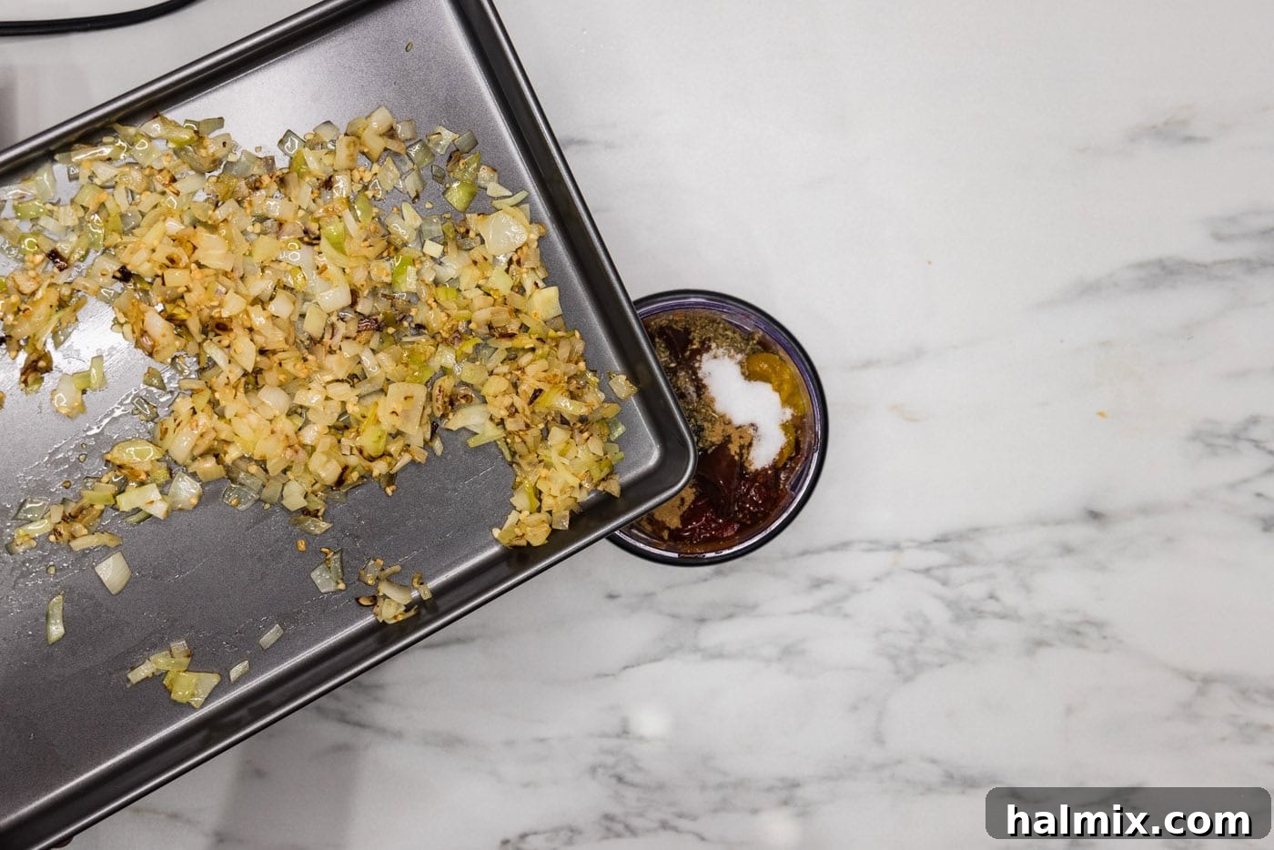 adding onion and garlic to food processor with chicken tinga ingredients