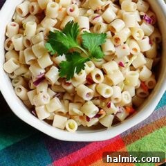 A close up overhead of three ingredient quick pasta salad in a bowl with fresh parley on top.