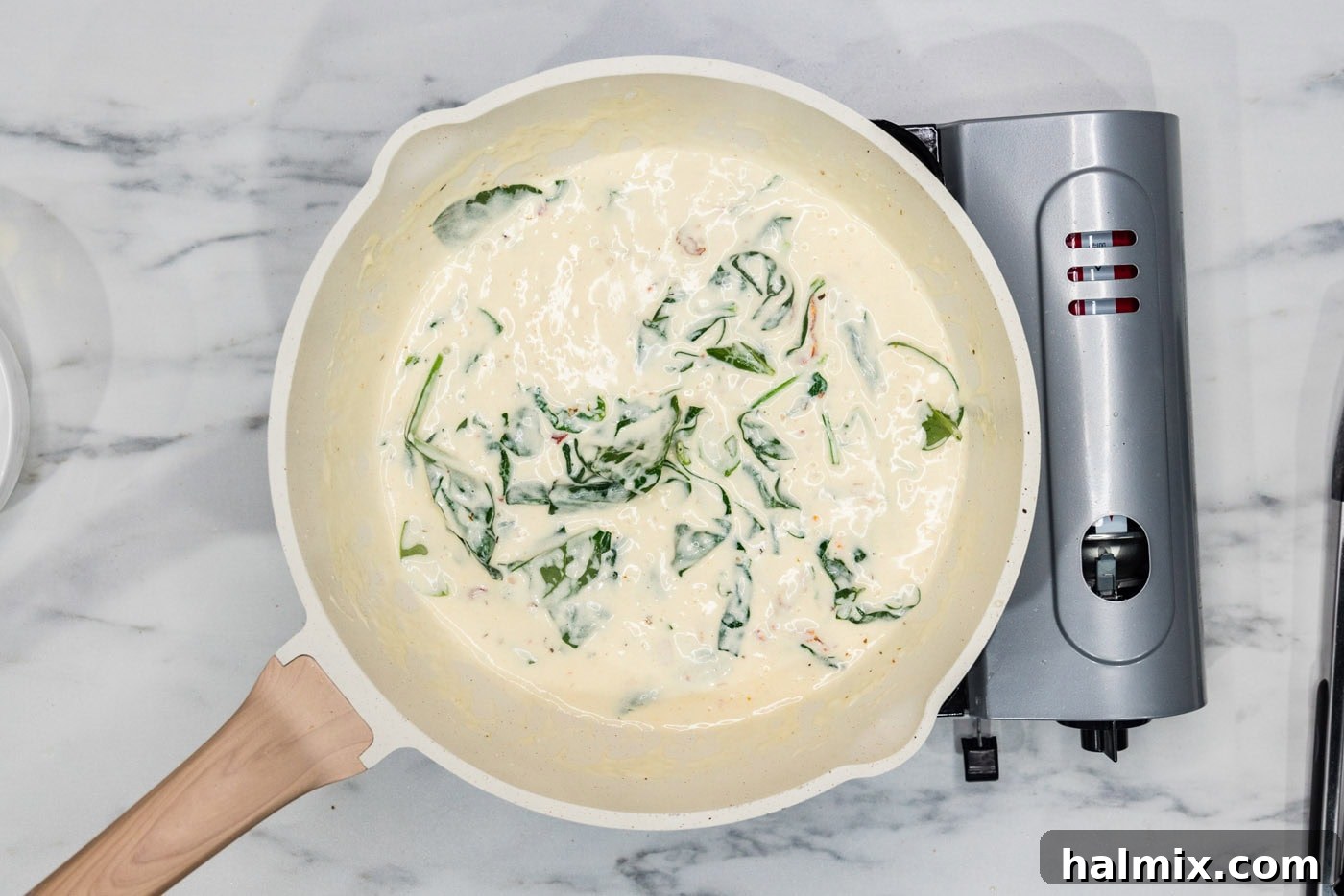 spinach in cream sauce in a skillet