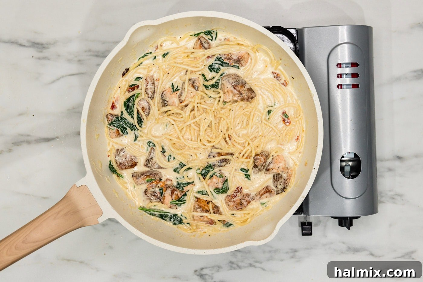 salmon pasta in a skillet with cream sauce