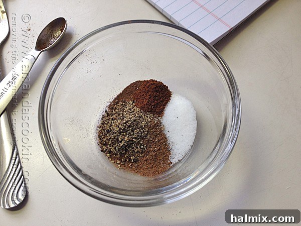 A small bowl containing a mixture of spices to be rubbed on the beef roast.