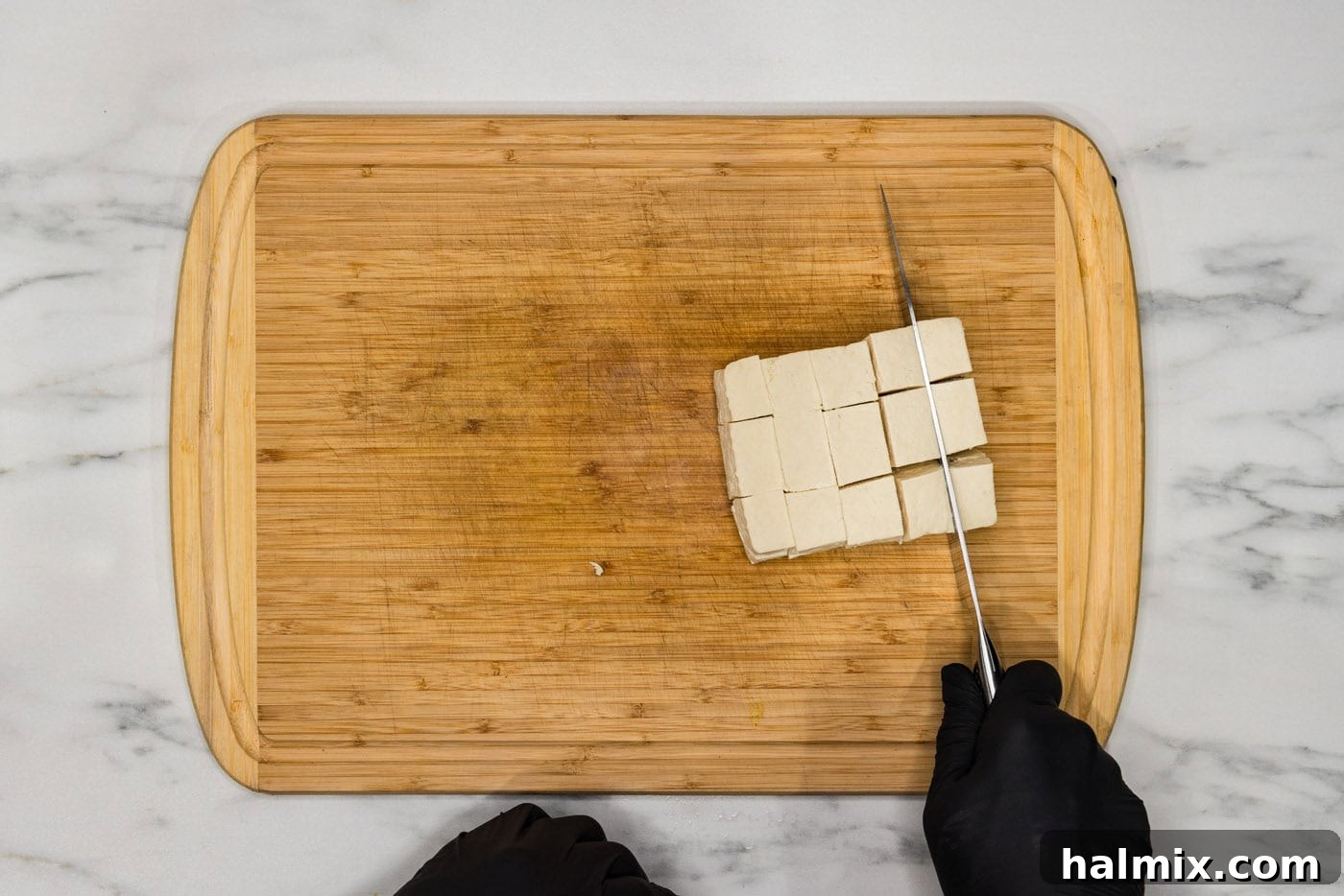 slicing tofu into cubes
