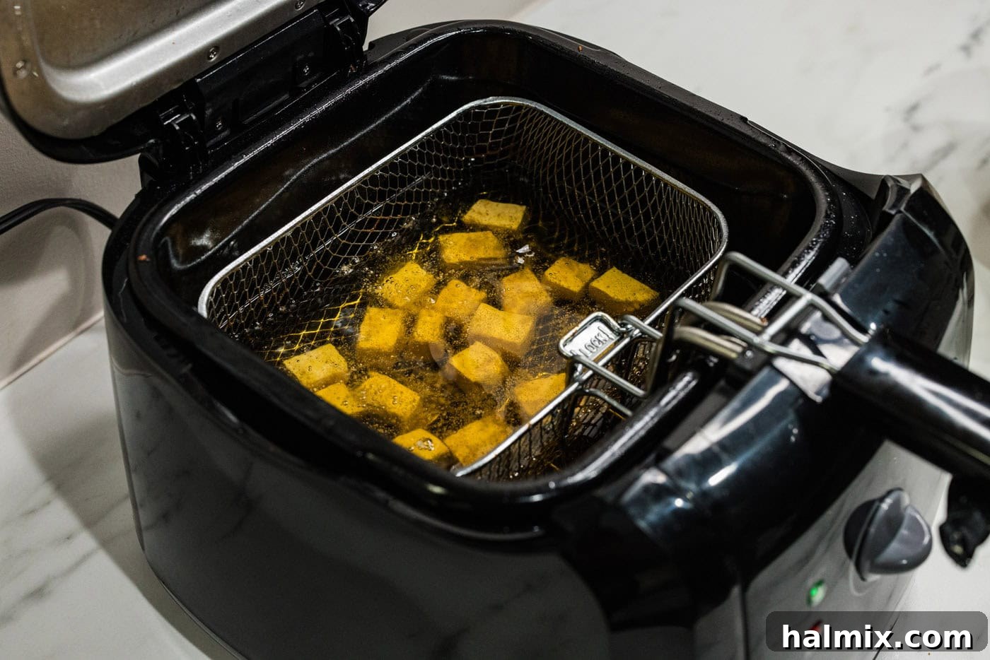 frying tofu in a deep fryer