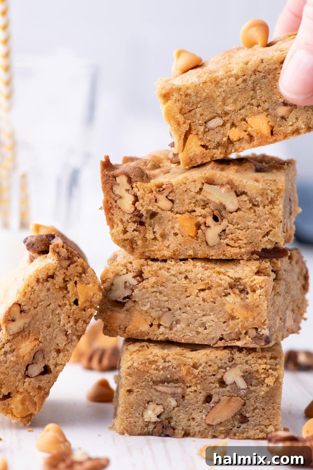 Hand grabbing a Butterscotch Brownie off a stack of brownies