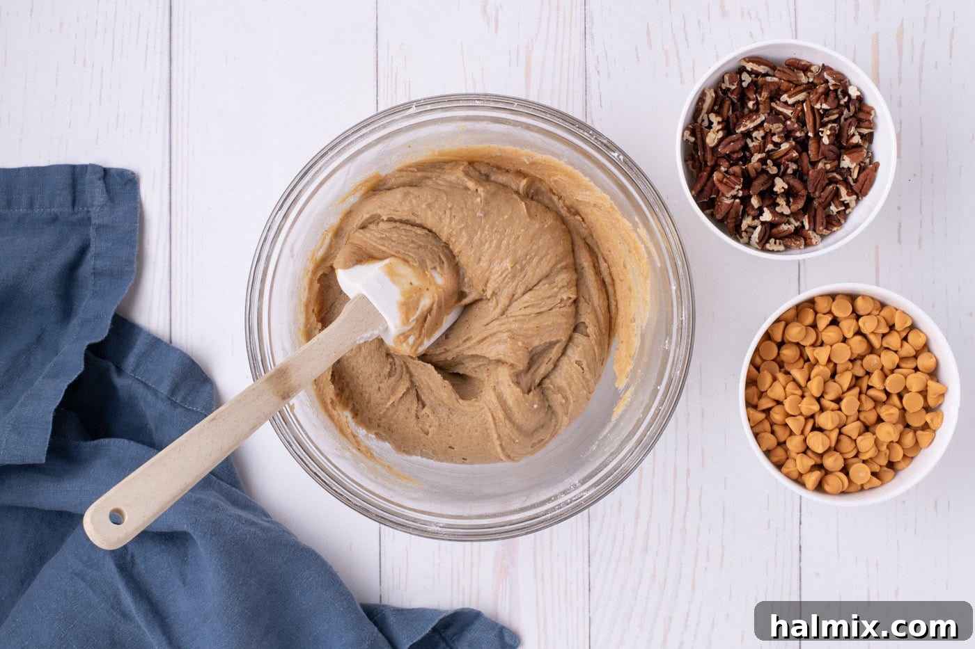blondies batter in a mixing bowl with a rubber spatula