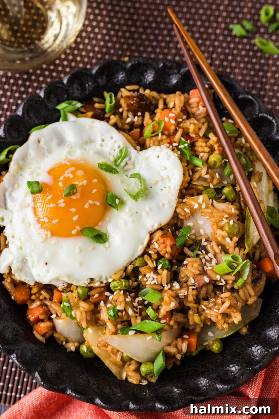 Close up photo of a bowl of Korean Fried Rice garnished with green onions