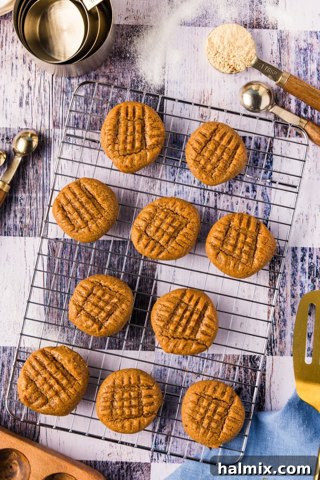 Keto Peanut Butter Cookies resting on a wire rack, golden brown and perfectly textured