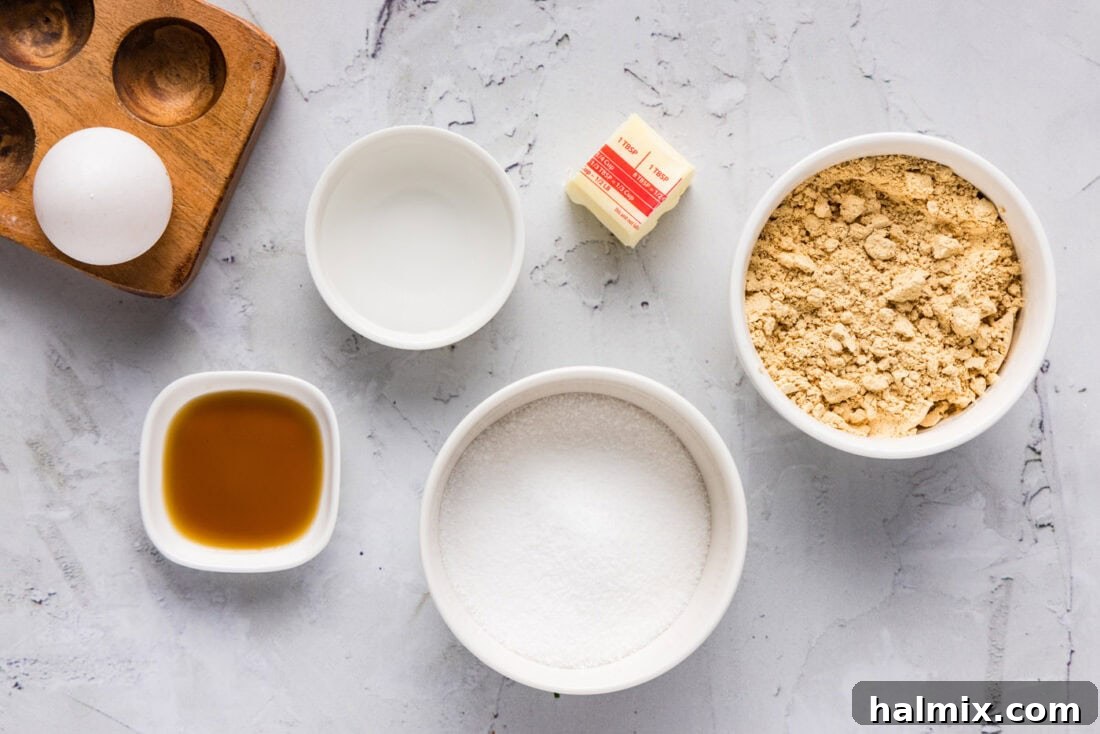 Ingredients for Keto Peanut Butter Cookies including peanut butter powder, egg, butter, and sweetener