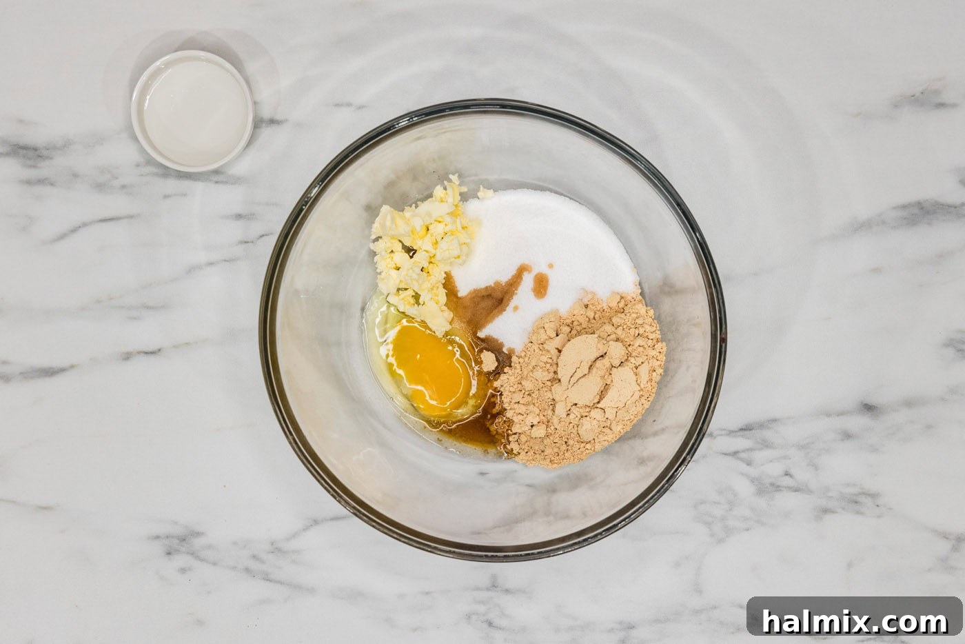peanut butter powder, egg, vanilla, sugar substitute, and butter in a bowl, ready to be mixed
