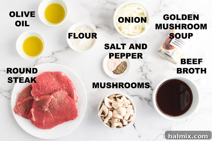 A curated selection of fresh ingredients laid out for preparing oven swiss steak