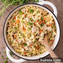 Creamy Chicken Pot Pie Pasta 6 Close up photo of a pot of Chicken Pot Pie Pasta with a spoon in it