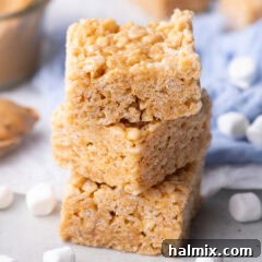 Close up photo of a stack of Peanut Butter Rice Krispie Treats, showing the delicious layers of crispy cereal and soft peanut butter marshmallow.