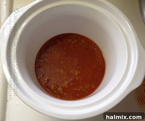 Combine salsa, broth, and green chiles in the slow cooker pot for a flavorful, aromatic base to your chicken dish.