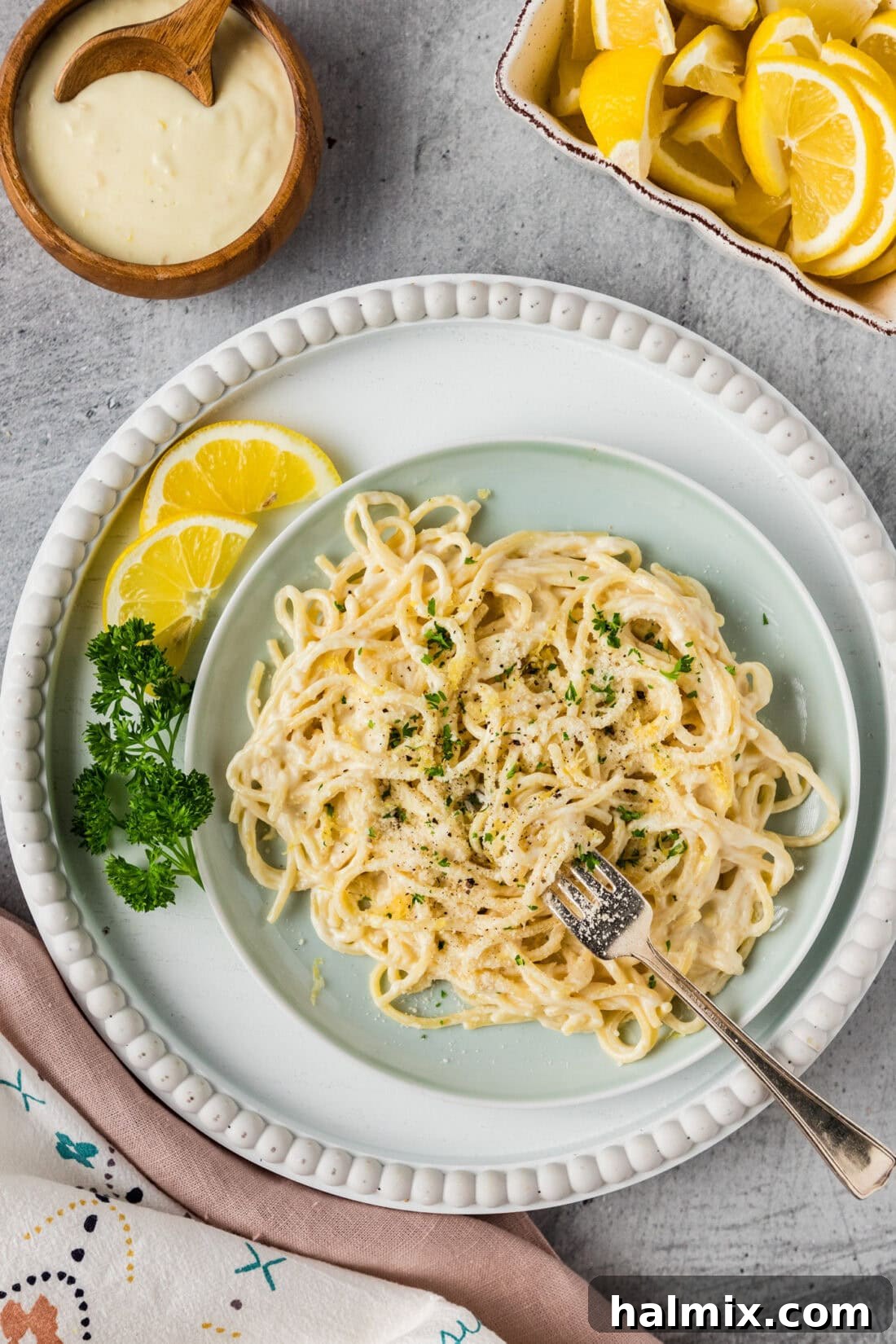 Zesty Lemon Cream Sauce 5 A beautifully presented plate of pasta generously coated in glossy Lemon Cream Sauce, garnished with fresh herbs.