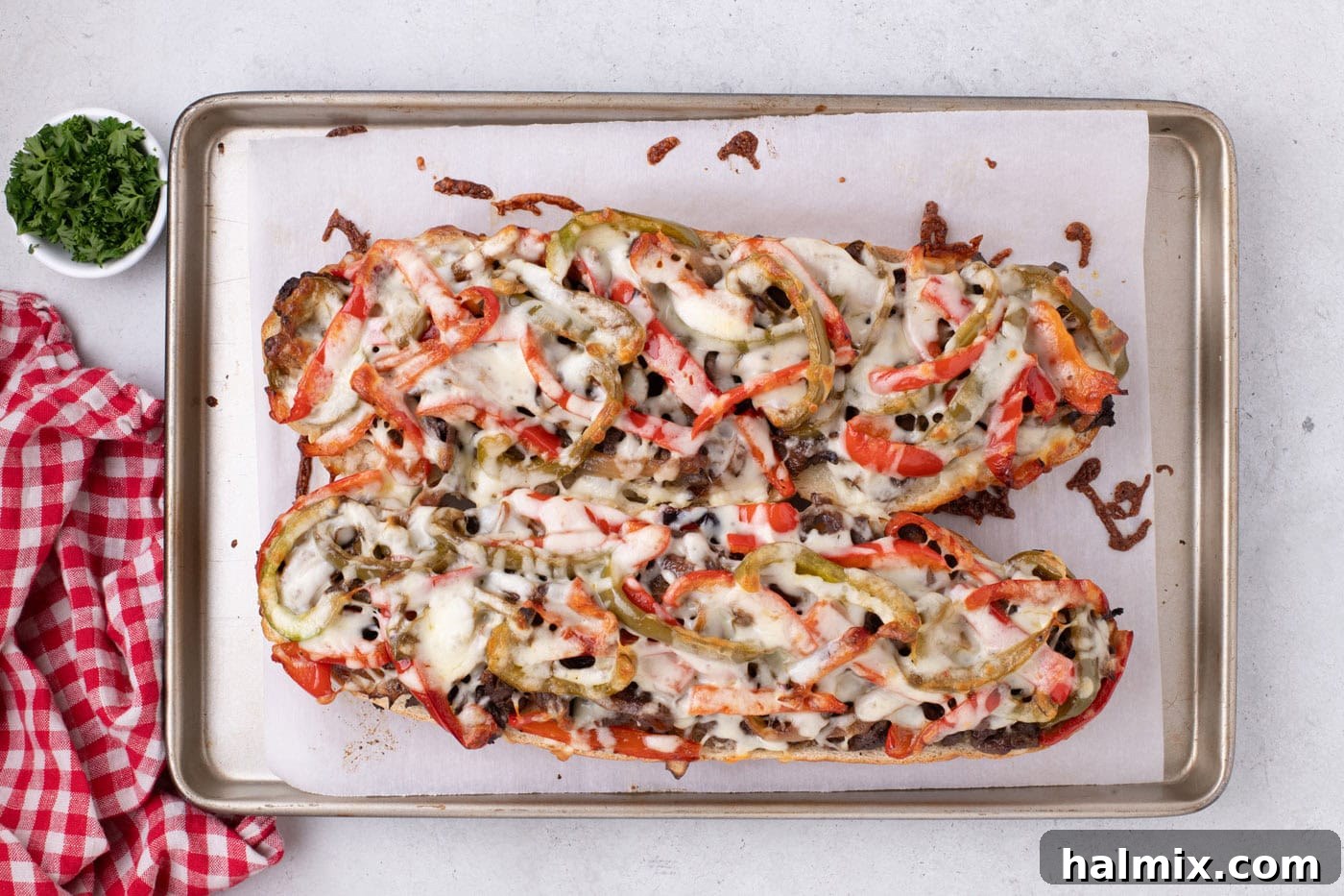 overhead of baked philly cheesesteak cheesy bread