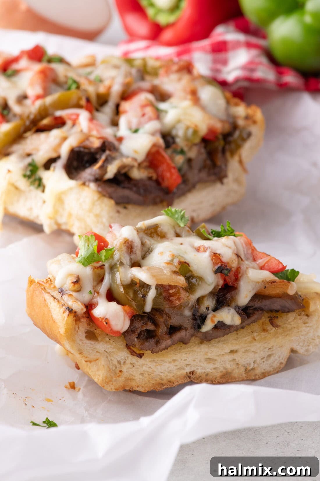 Close up photo of a slice of Philly Cheesesteak Cheesy Bread