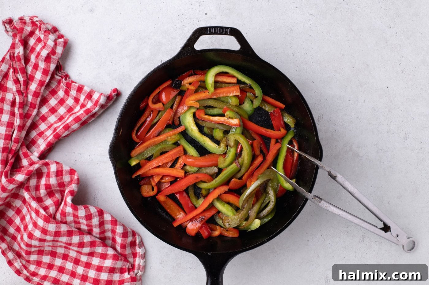 red and green bell peppers cooked in a skillet