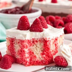 Close up photo of Raspberry Poke Cake on a plate with a bite removed
