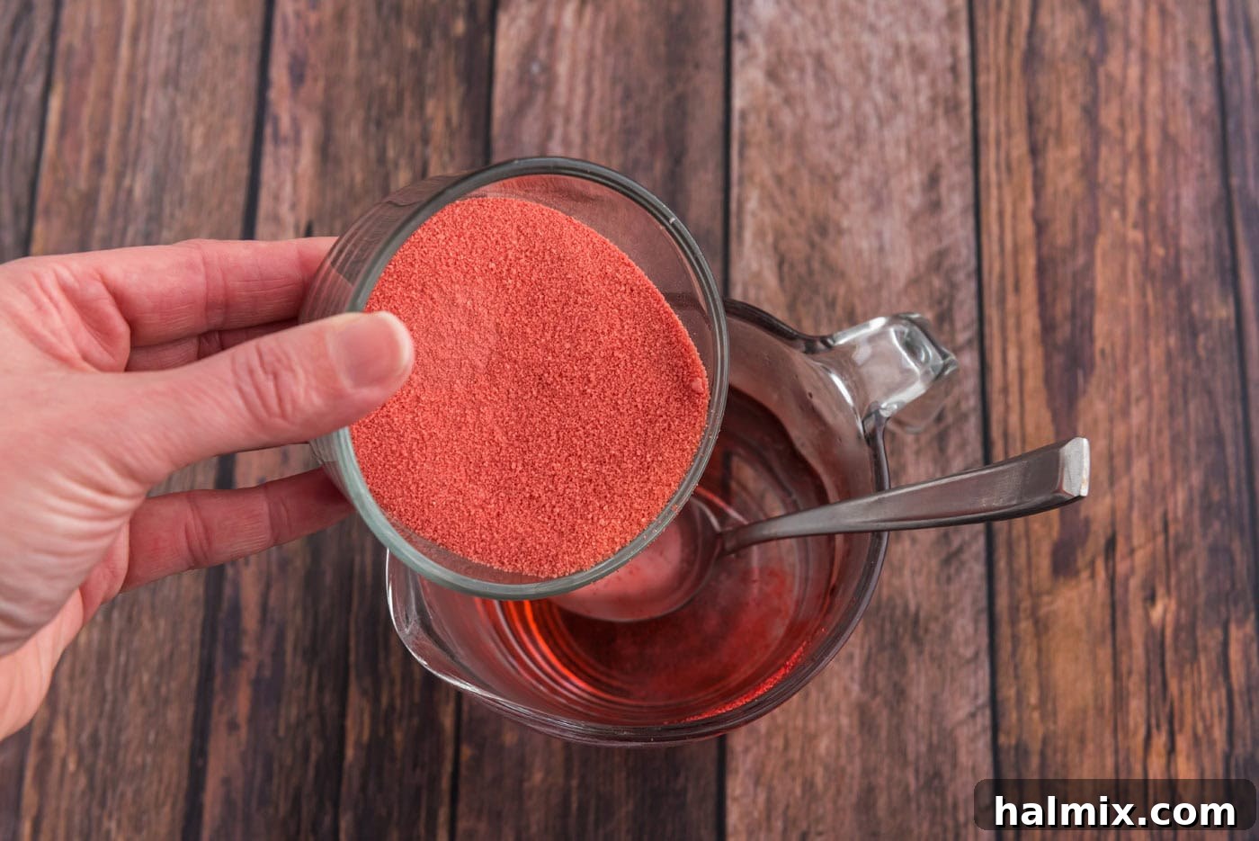 pouring powdered gelatin in a bowl of water