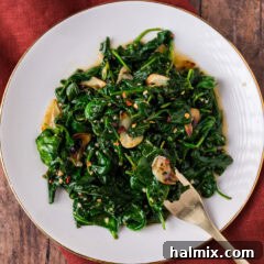 Plate of Stir Fried Spinach with a fork resting to the side