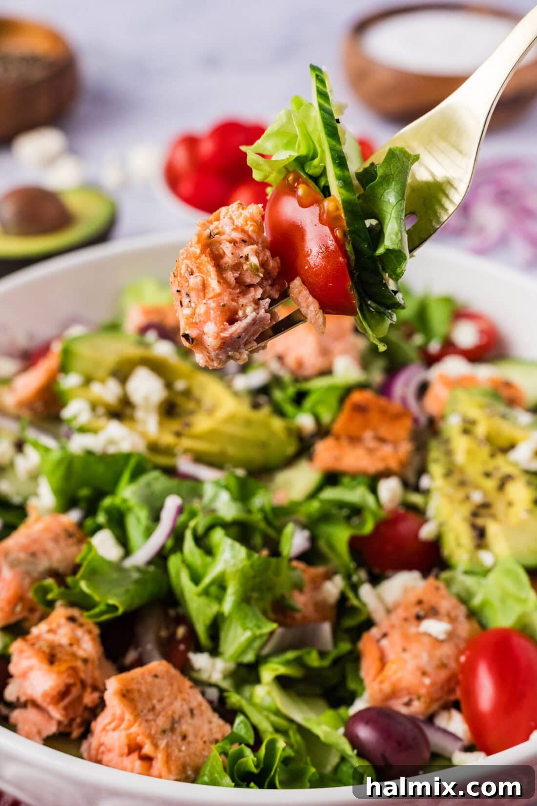 Vibrant Salmon Power Bowl 3 A forkful of Salmon Salad being lifted from a bowl, showcasing the fresh ingredients and flaky salmon