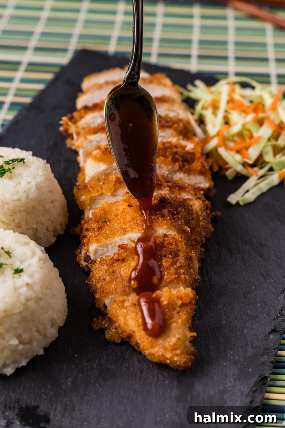 Golden Crispy Chicken Delight 12 A delicious glaze being artfully drizzled over freshly fried Chicken Katsu slices.