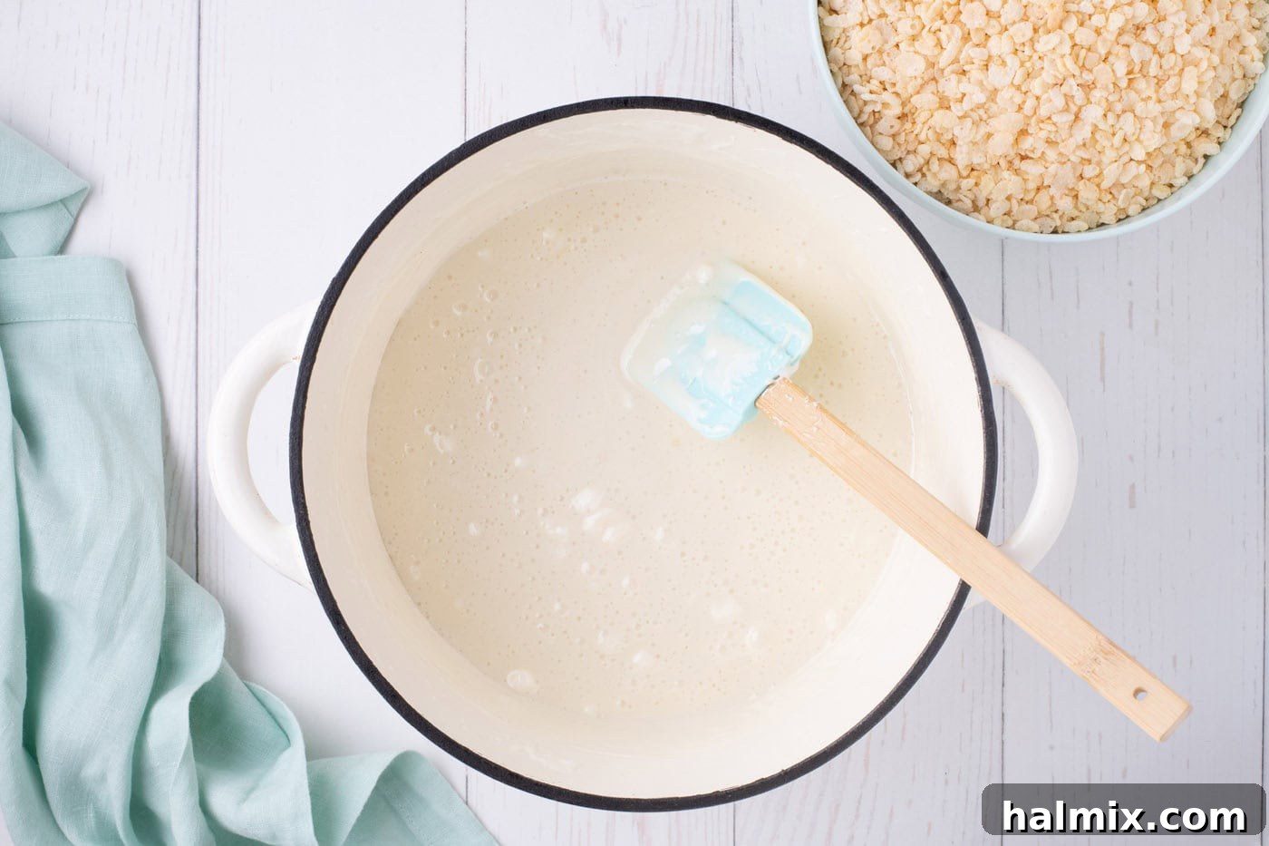Carrot Cake Krispie Bites 5 Melted marshmallows in a pot with a rubber spatula, smooth and ready for cereal