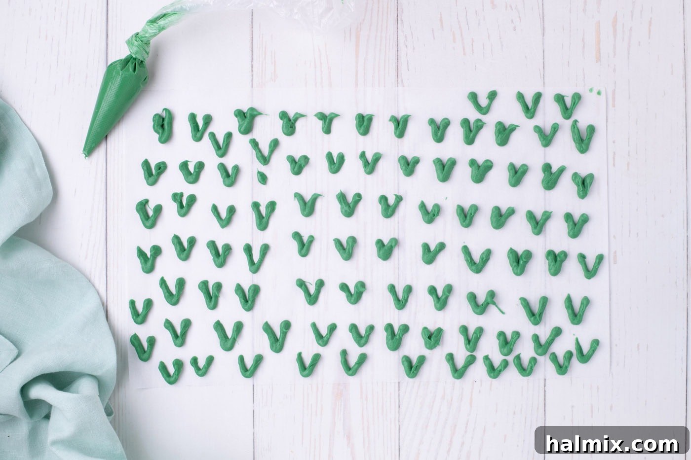 Carrot Cake Krispie Bites 7 Piped green chocolate 'V' shapes on parchment paper, drying to form carrot stems