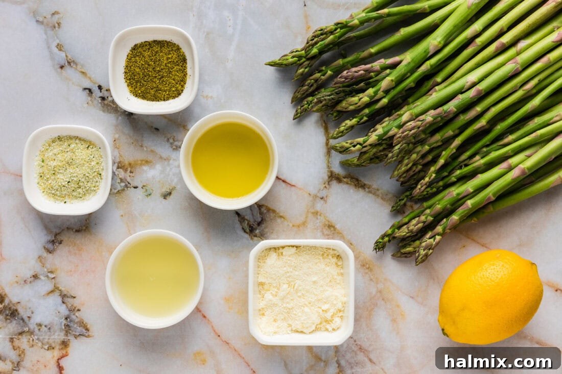 Bright Lemon Asparagus 4 Ingredients laid out for Lemon Asparagus, including fresh asparagus, a whole lemon, butter, and seasonings