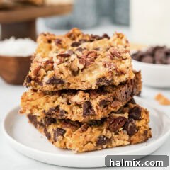 Close up photo of a stack of Magic Bars, highlighting their appealing texture.