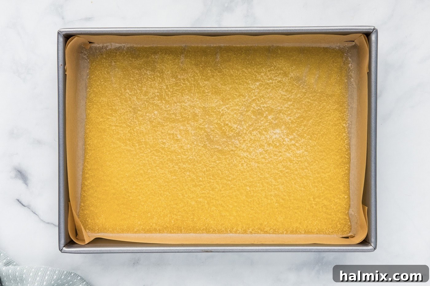 Melted butter evenly spread in a 9x13 inch baking pan.