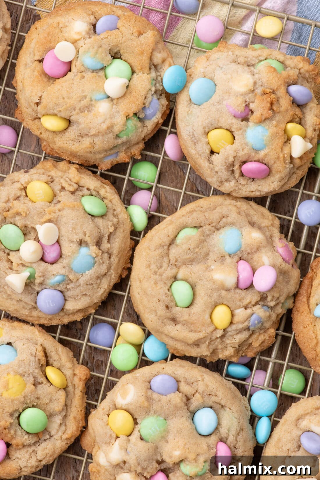 Freshly baked Easter M&M Cookies resting on a wire rack, showcasing their vibrant colors and perfect golden-brown edges.