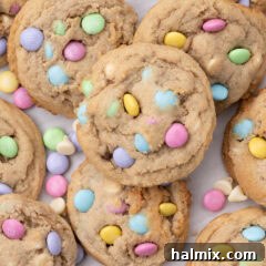 Close up photo of a pile of Easter M&M Cookies, highlighting their vibrant colors and appealing texture.