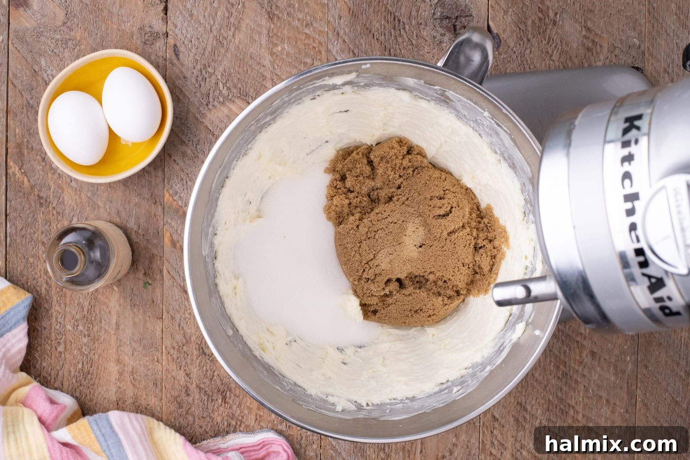 Granulated and brown sugars added to the beaten butter mixture in a stand mixer.