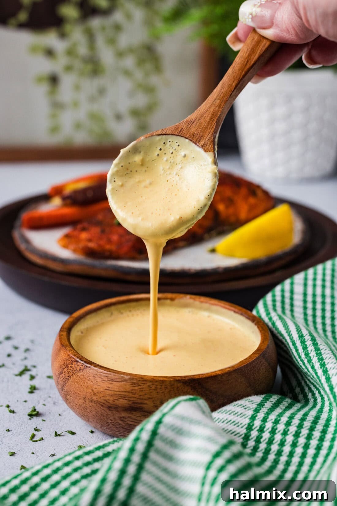 Spoon pouring Remoulade Sauce into a bowl