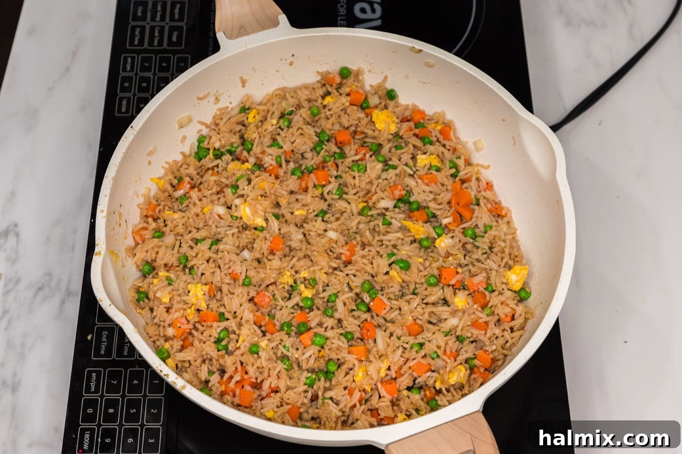 Vegetable fried rice in a skillet, with all ingredients perfectly combined